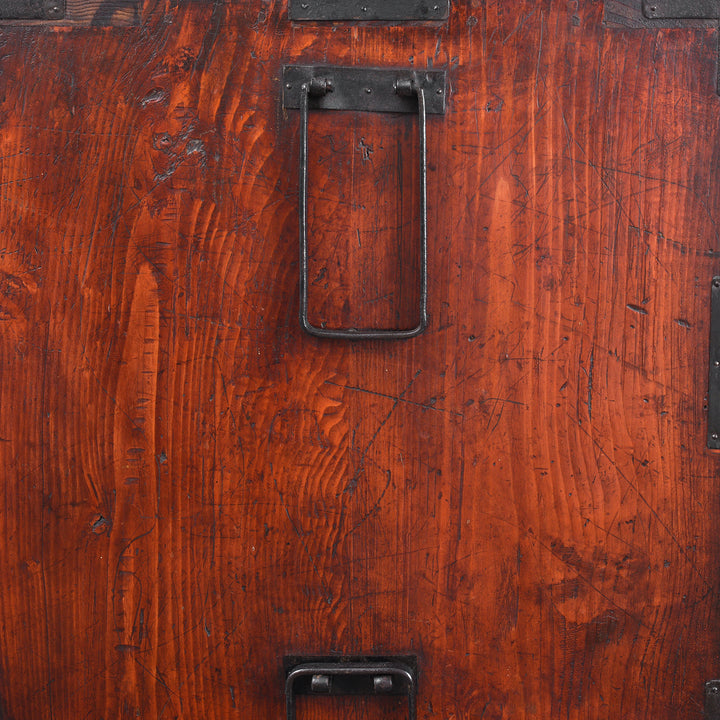 Handle Detail From Side Of Antique Japanese Tansu Chest With Lacquered Wood Finish And Ornate Iron Hardware