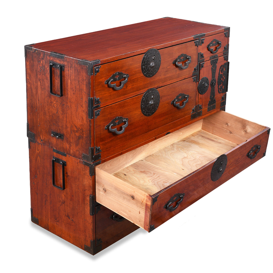 Open Drawer View Of Antique Japanese Tansu Chest With Lacquered Wood Finish And Ornate Iron Hardware