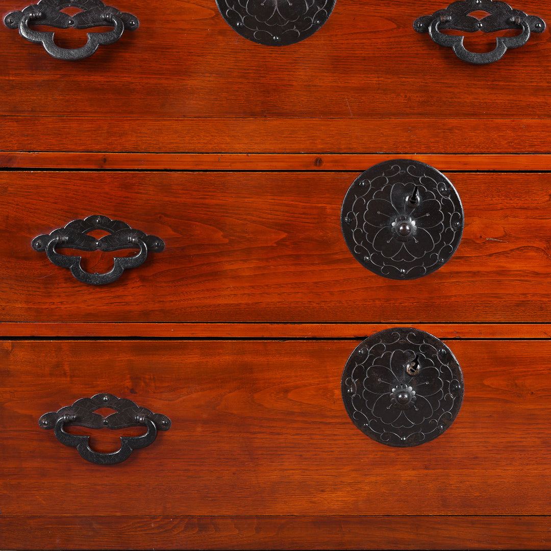 Detail View Of Handles From Antique Japanese Tansu Chest With Lacquered Wood Finish And Ornate Iron Hardware