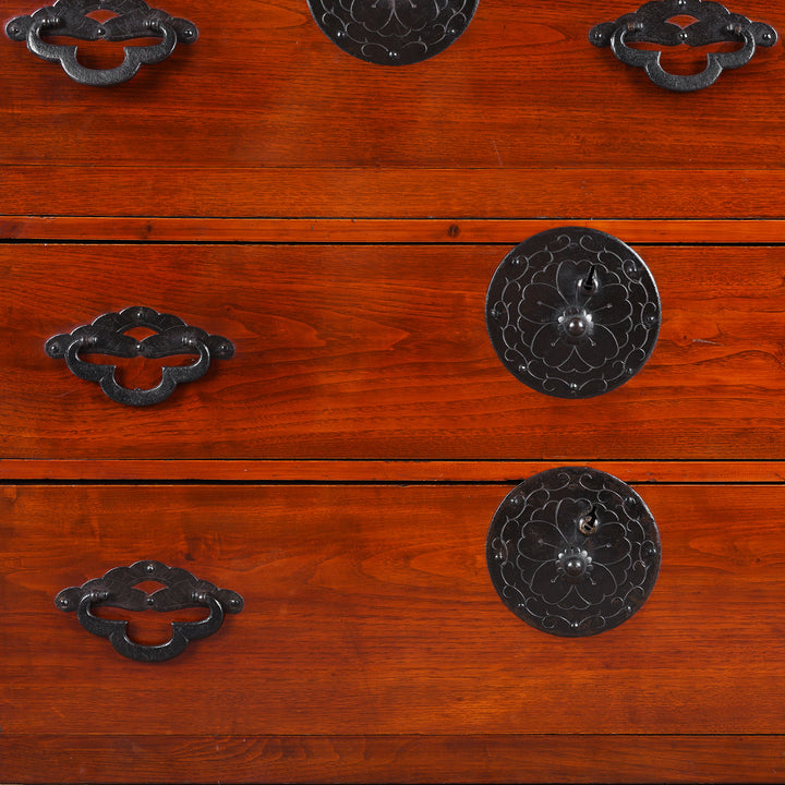 Detail View Of Handles From Antique Japanese Tansu Chest With Lacquered Wood Finish And Ornate Iron Hardware
