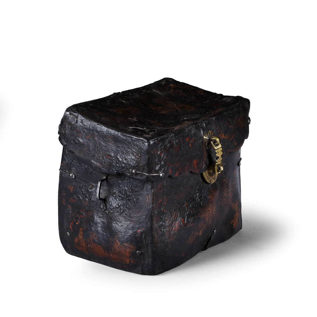 Angled VIew Of Tibetan Leather Saddle Box With Brass Script Clasp And Patinated Surface
