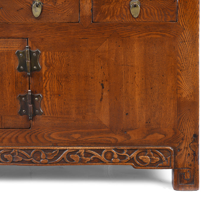 Carving Detail From Nineteenth Century Burr Elm Chinese Kang Cabinet With Drawers Brass Hardware And Carved Apron