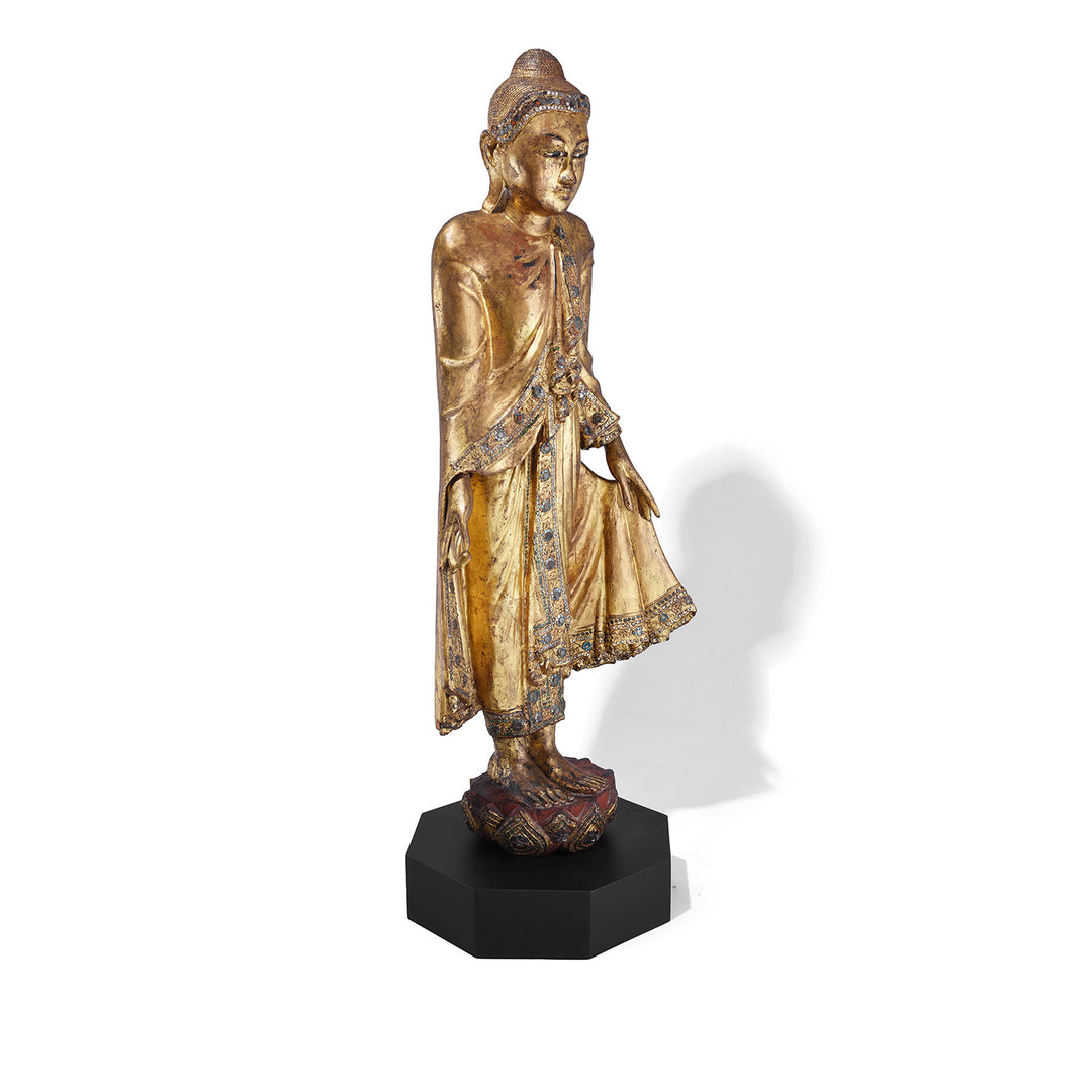 Angled VIew Of Gilded Teak Standing Mandalay Buddha From Burma With Coloured Glass Inlay And Lotus Base | Indigo Antiques