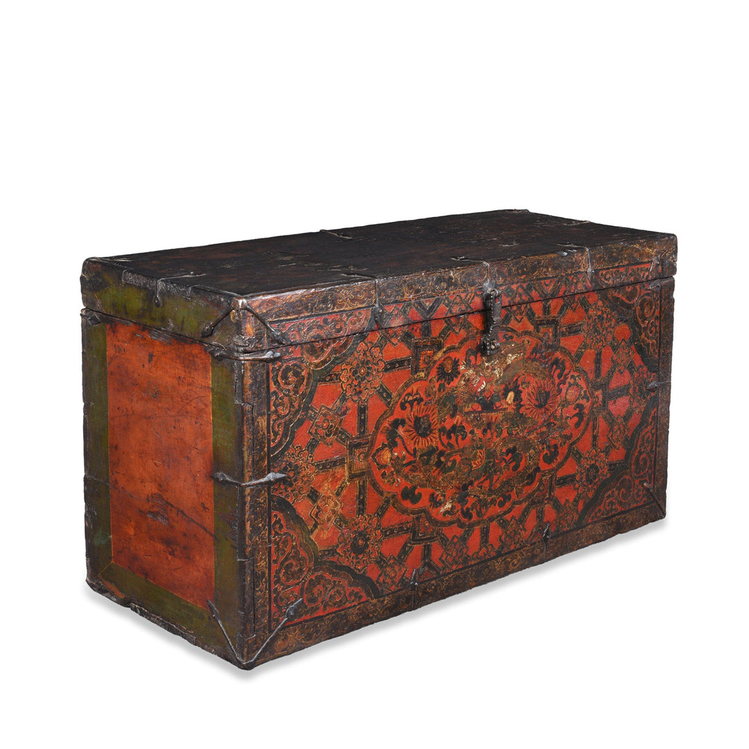 Angled View Of Antique Tibetan Painted Storage Chest With Red And Gold Floral Motif And Central Dragon Design