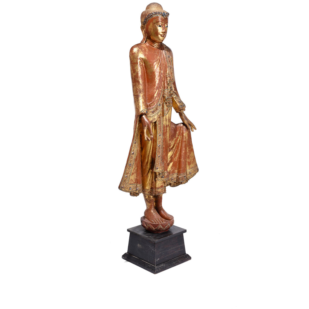 Angled View Of Gilded Teak Standing Mandalay Buddha From Burma With Inlaid Glass And Myrobalan Fruit