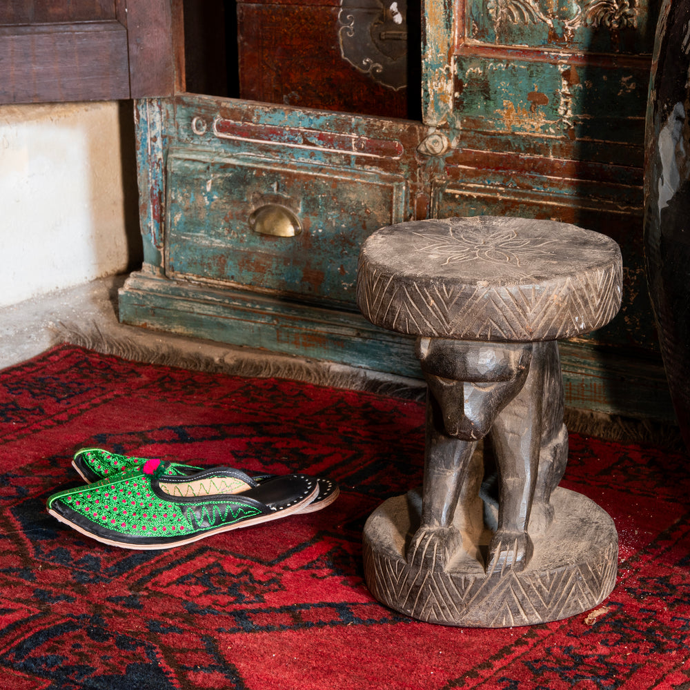 Vintage Indian Santal Tribal Monkey Stool Next To Indian Jutti Slippers | Indigo Antiques