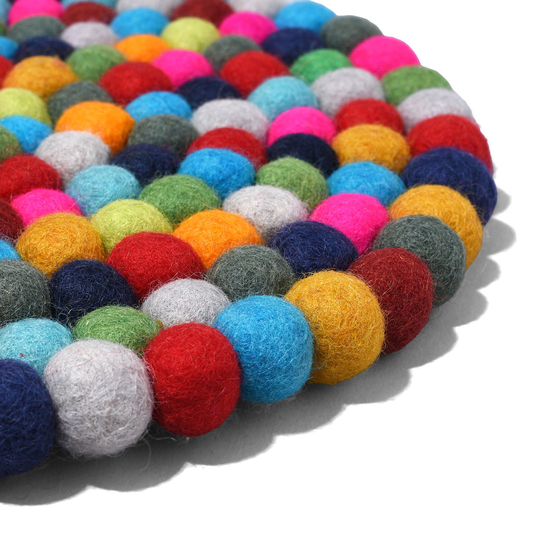 Angled View Of Handmade 28cm multi-coloured felt ball singing bowl cushion from Nepal, crafted from individually hand-felted wool balls to provide a stable and protective base for Tibetan singing bowls