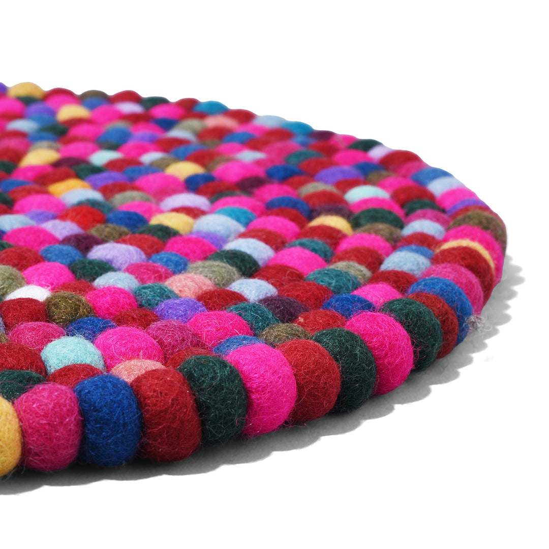 Angled View Of Handmade 35cm multi-coloured felt ball singing bowl cushion from Nepal, crafted from individually hand-felted wool balls to provide a stable and protective base for Tibetan singing bowls
