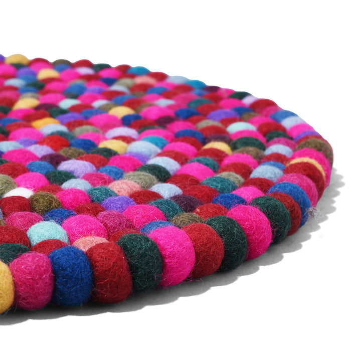 Angled View Of Handmade 35cm multi-coloured felt ball singing bowl cushion from Nepal, crafted from individually hand-felted wool balls to provide a stable and protective base for Tibetan singing bowls