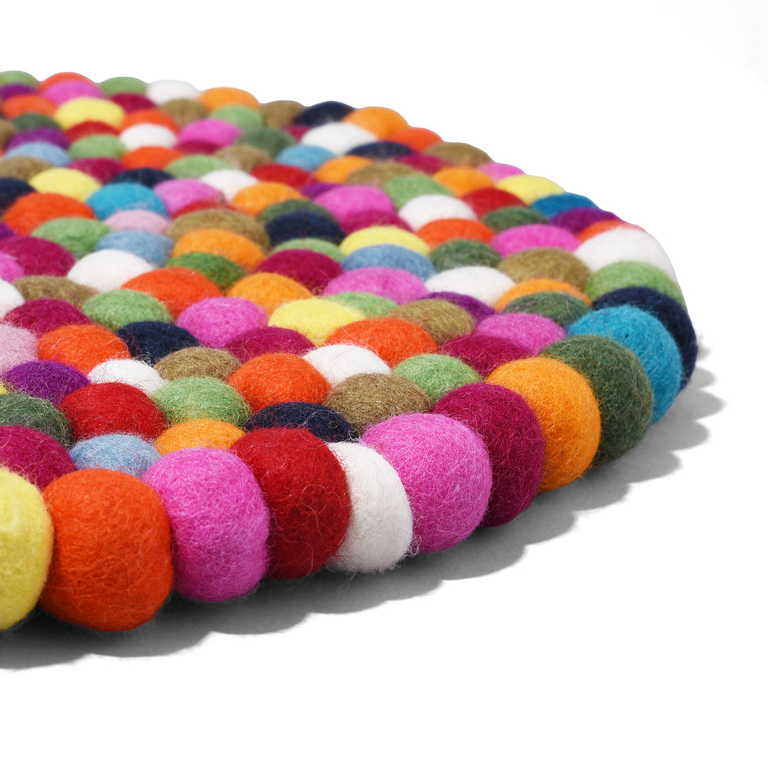 Angled View Of Handmade 40cm multi-coloured felt ball singing bowl cushion from Nepal, crafted from individually hand-felted wool balls to provide a stable and protective base for Tibetan singing bowls.