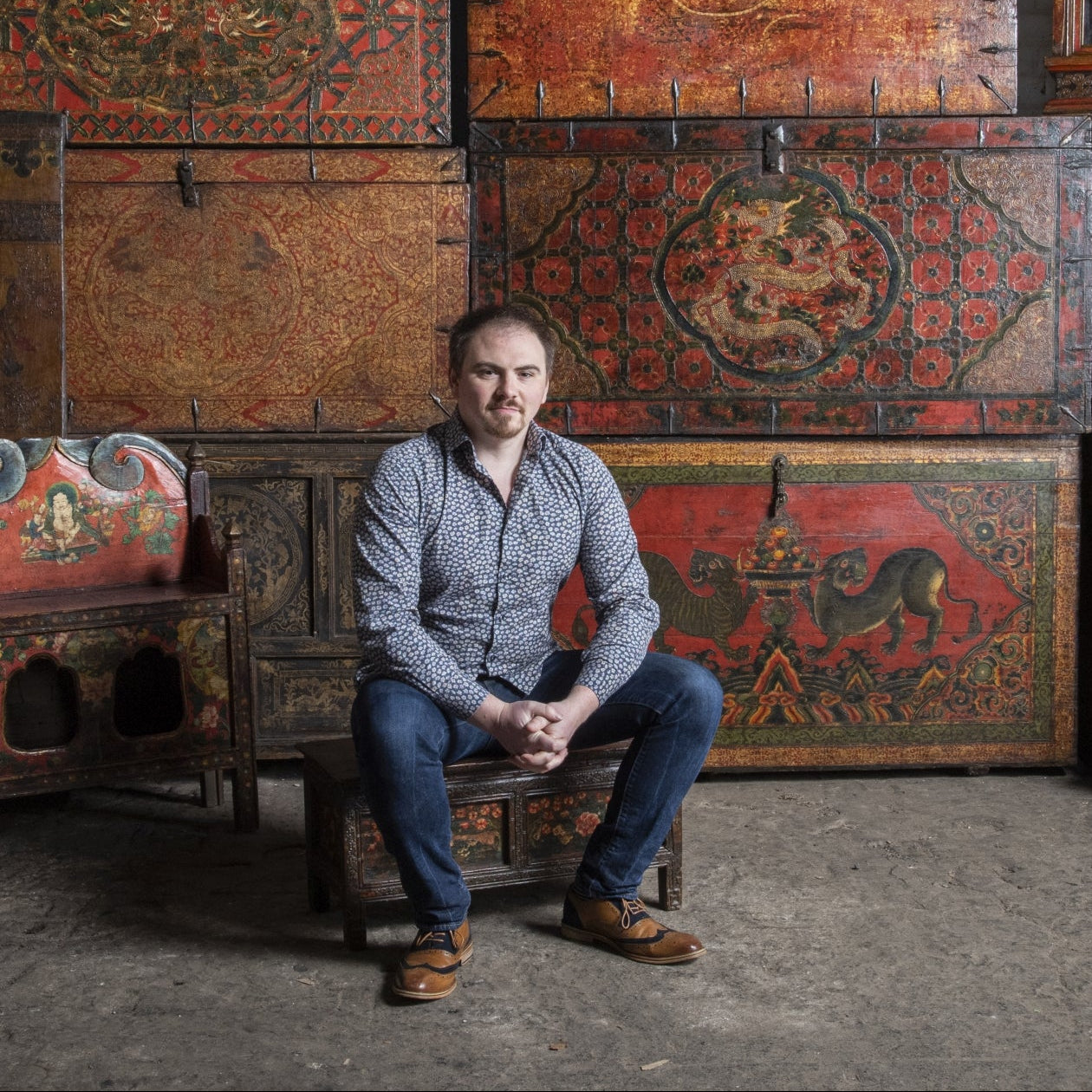 Tom Lightbown, director of Indigo Antiques in front of Tibetan antique furniture