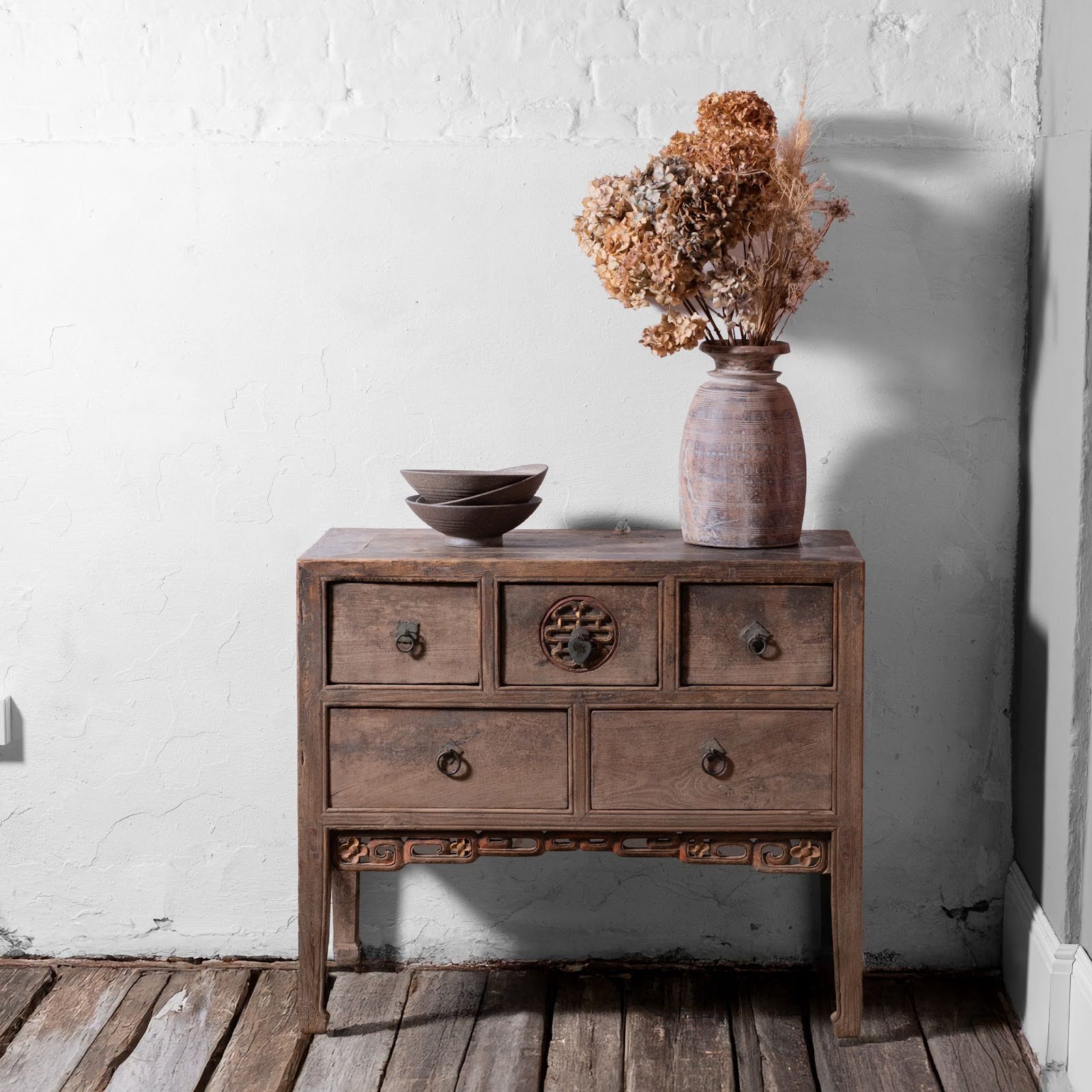 Antique wooden sideboard with vase