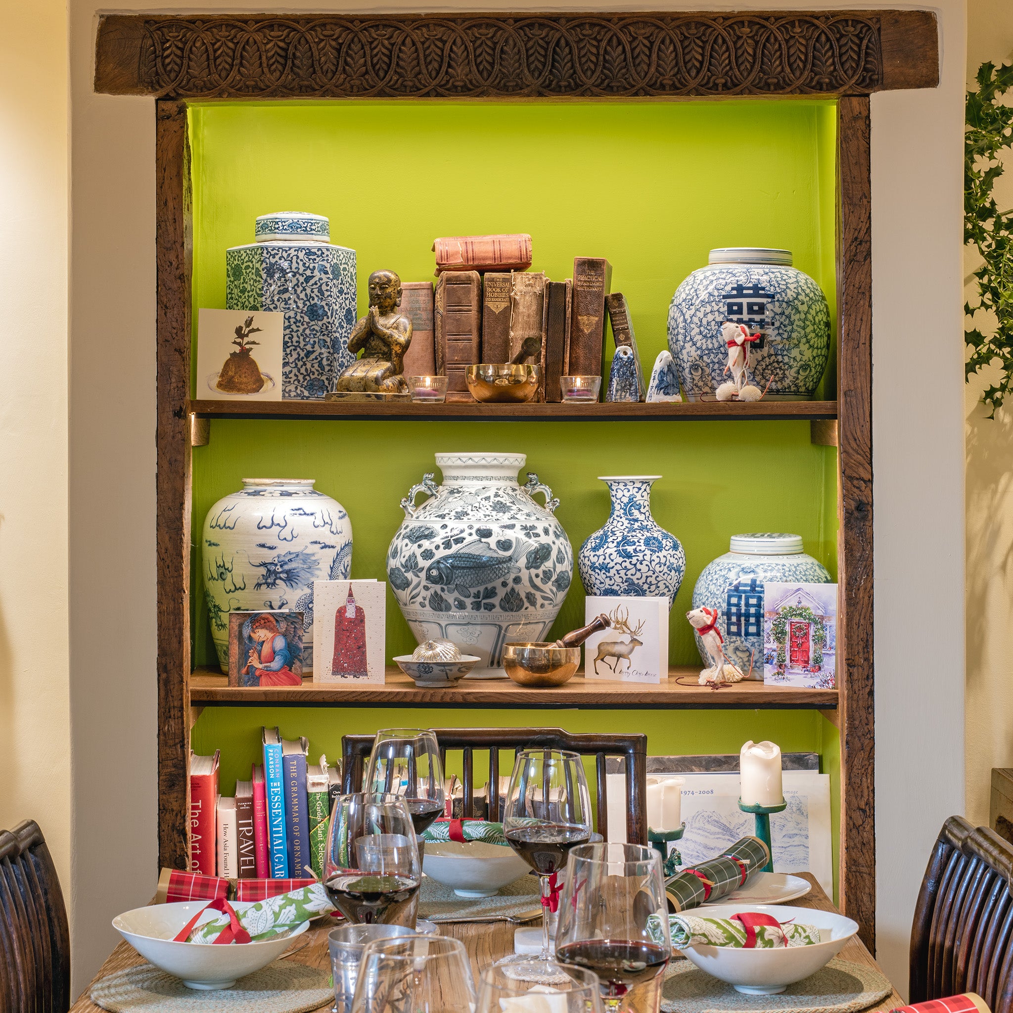 Chinese ginger jars and other pots displayed on a bookshelf