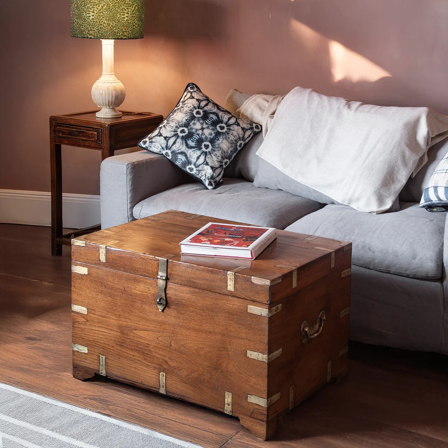 Antique trunk made into a coffee table in a living room