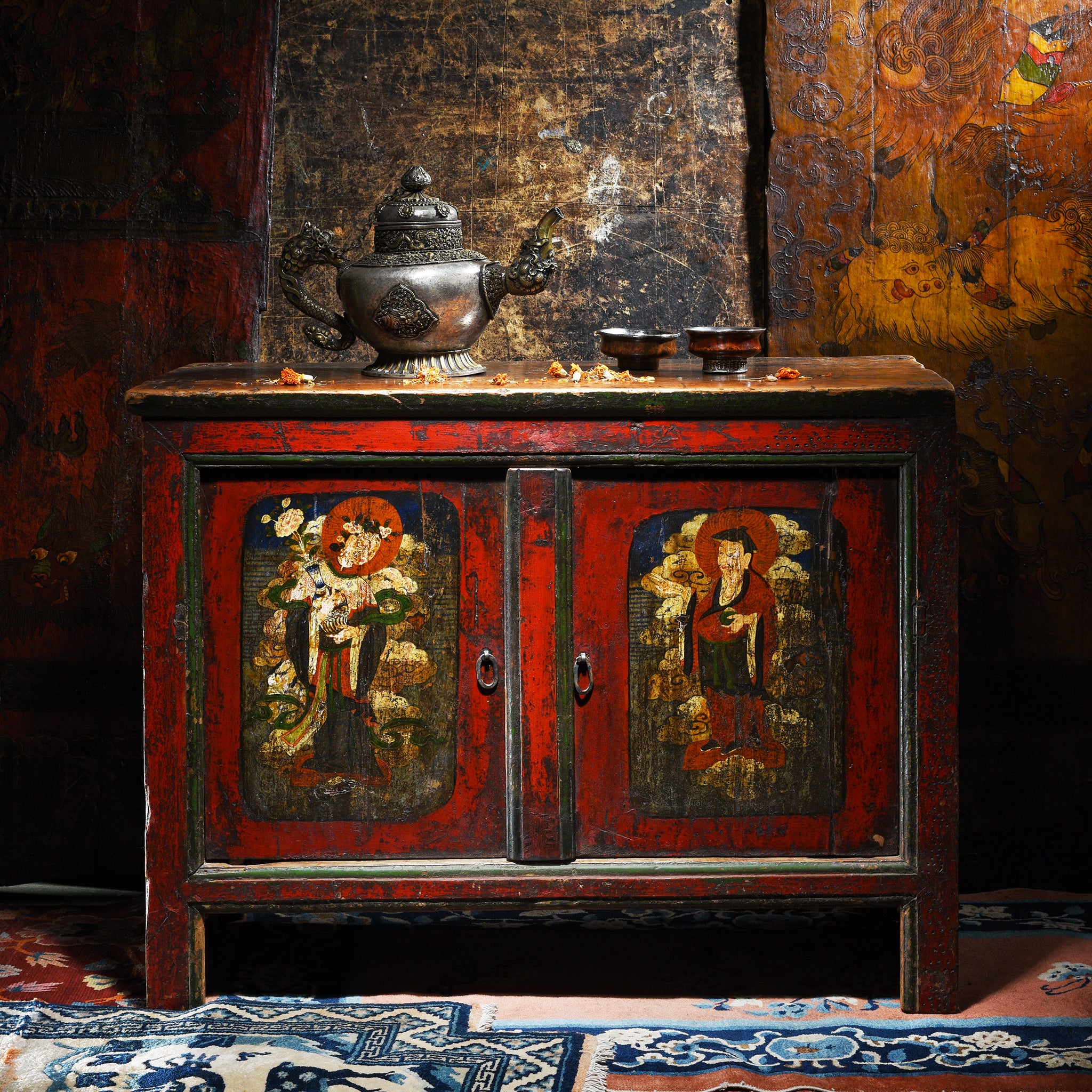 An antique red cabinet with other painted details