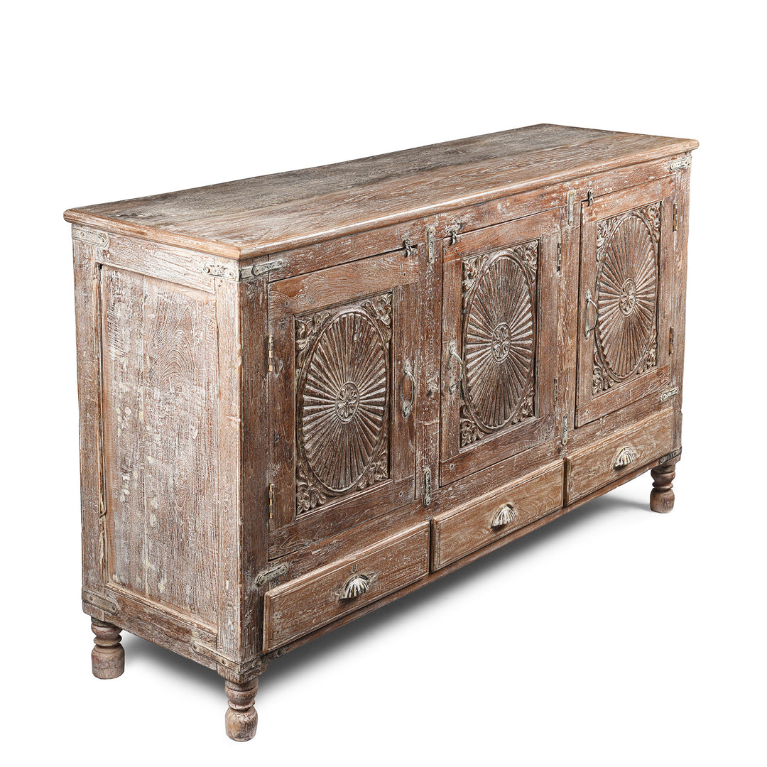 Angled View Of Antique Carved Teak Sideboard With Sunburst Panels - 19th Century | Indigo Antiques