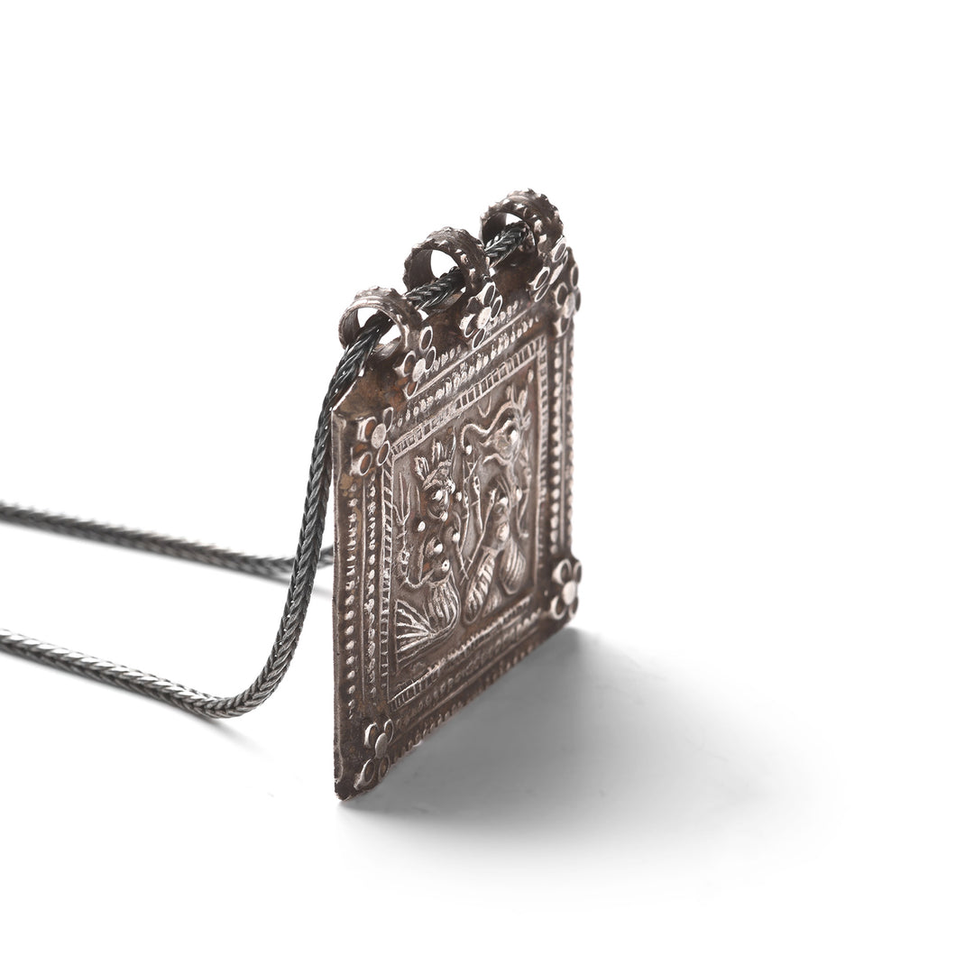Angled View Of Tribal Indian Silver Ganesh & Parvati Amulet - 19thC | Indigo Antiques