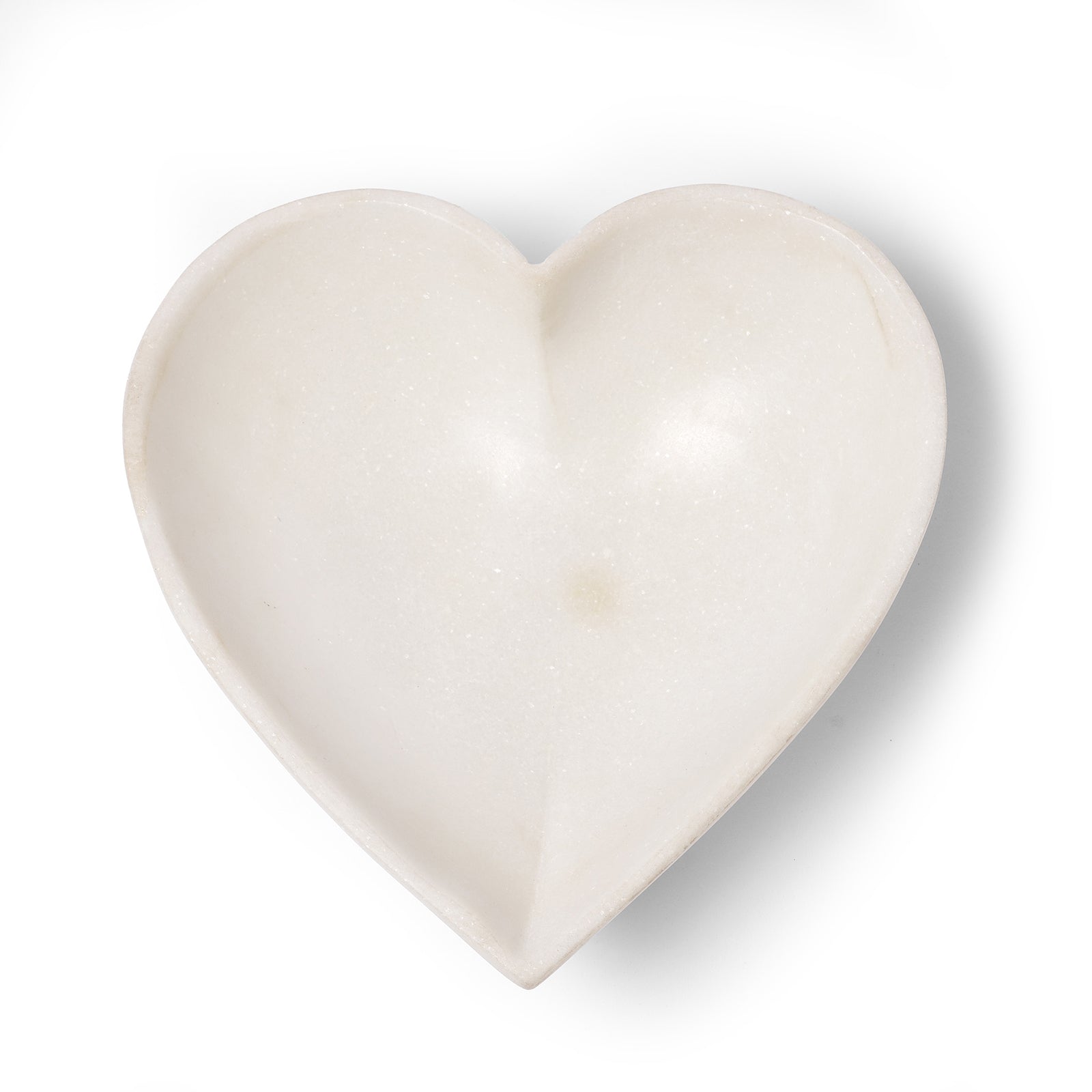 A mughal style white marble heart shaped bowl handmade in India filled with strawberries