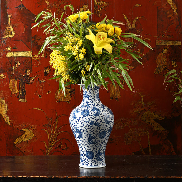 Reproduction Chinese Blue & White Porcelain Flower Vase with Chrysanthemums in front of a Chinese Red Lacquer Cabinet | Indigo Antiques