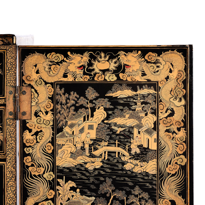 Dragon detail from a Gilt black lacquer Chinese export chinoiserie table cabinet. Antique & made in Canton. Similar to examples found in the Peabody Essex Museum. Exceptional quality | Indigo Antiques