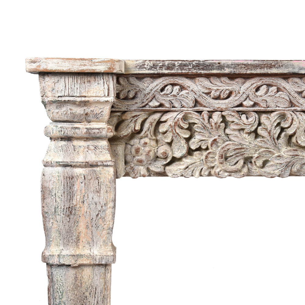 Detailed carving and leg from an Indian reclaimed wood console table made using reclaimed teak carvings