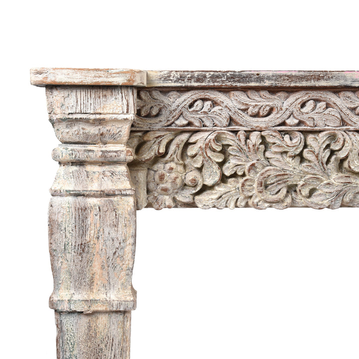 Detailed carving and leg from an Indian reclaimed wood console table made using reclaimed teak carvings