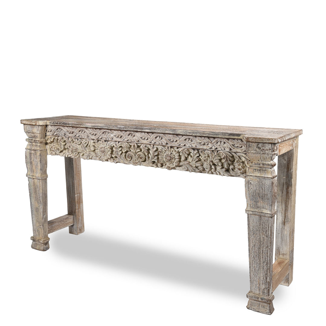 Detailed carving and leg from an Indian reclaimed wood console table made using reclaimed teak carvings