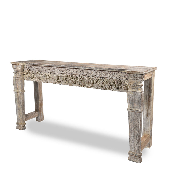 Detailed carving and leg from an Indian reclaimed wood console table made using reclaimed teak carvings