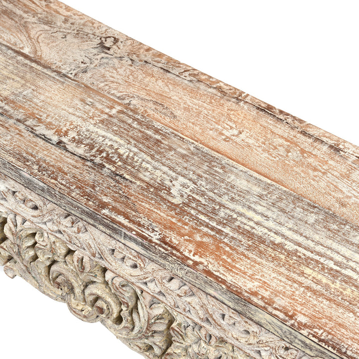 Detailed carving and leg from an Indian reclaimed wood console table made using reclaimed teak