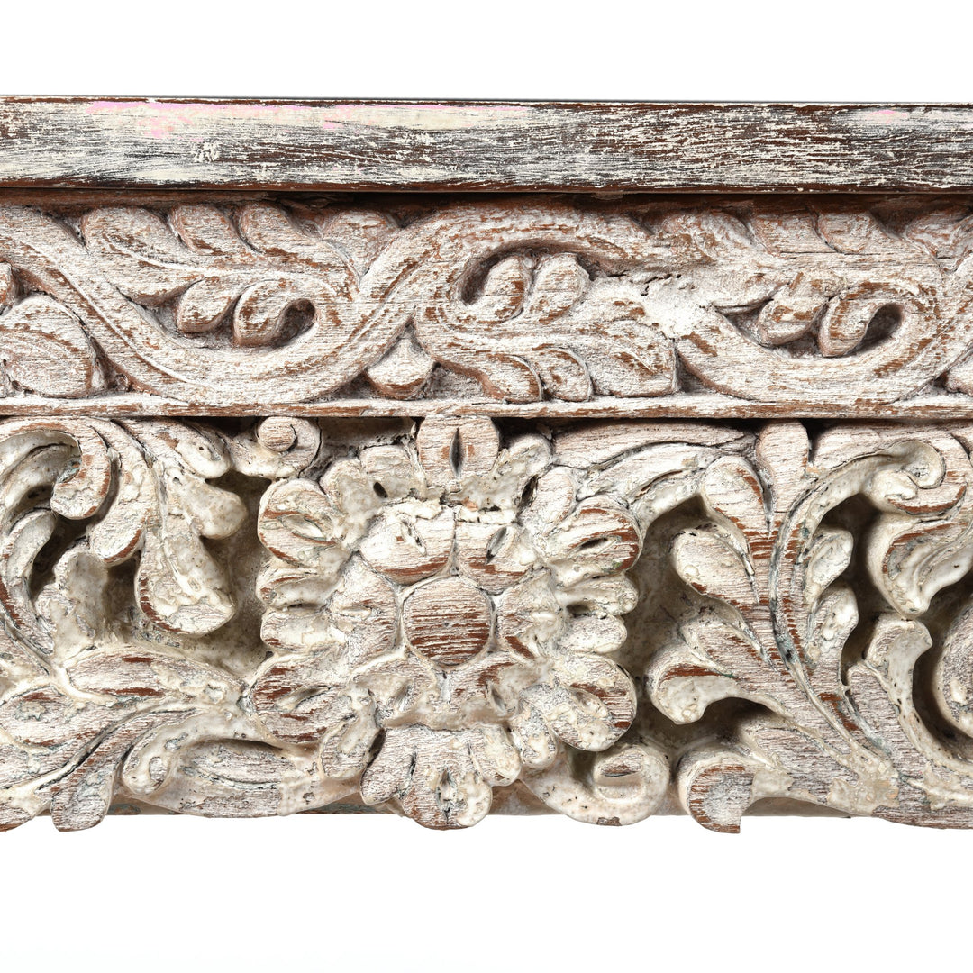 Detailed carving and leg from an Indian reclaimed wood console table made using reclaimed teak carvings