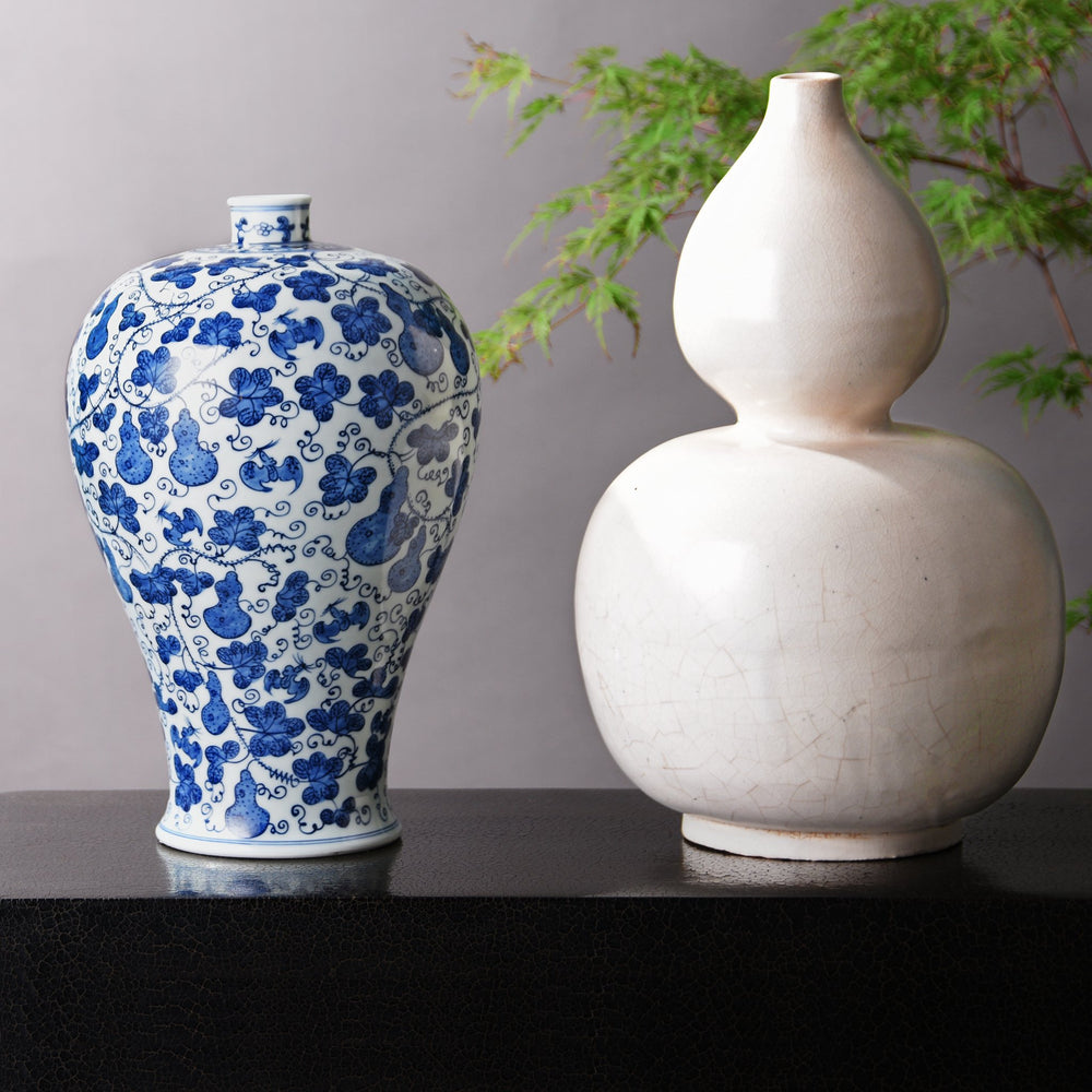 Chinese blue & white gourd meiping vase alongside a "double gourd" white porcelain vase. Our museum quality Chinese porcelain vases are all hand made and hand painted