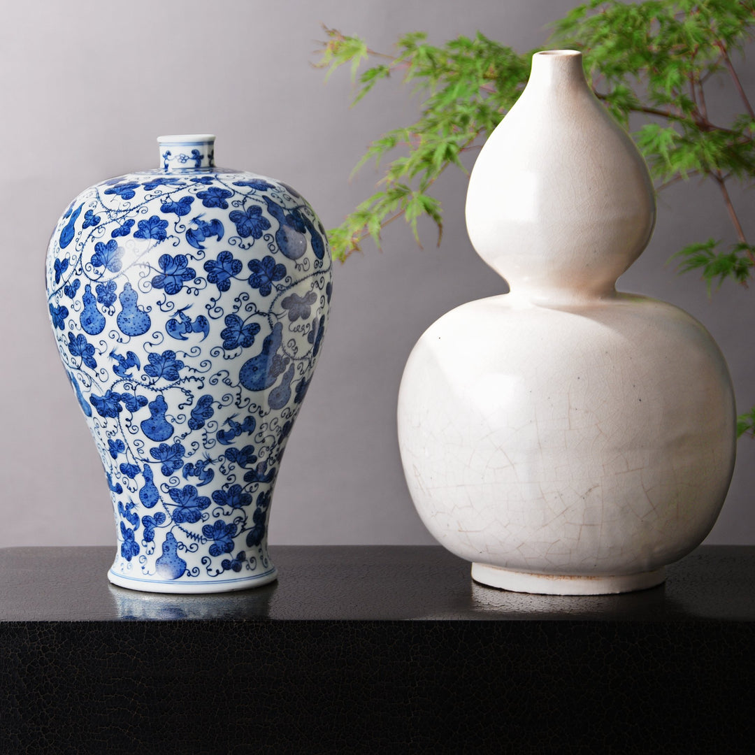 Chinese blue & white gourd meiping vase alongside a "double gourd" white porcelain vase. Our museum quality Chinese porcelain vases are all hand made and hand painted