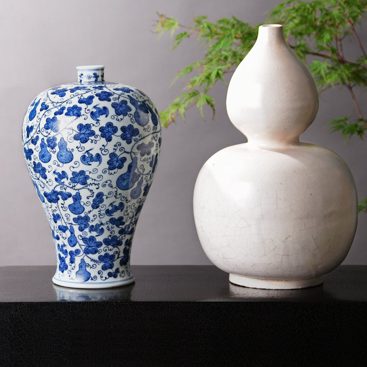 Chinese blue & white gourd meiping vase alongside a "double gourd" white porcelain vase. Our museum quality Chinese porcelain vases are all hand made and hand painted