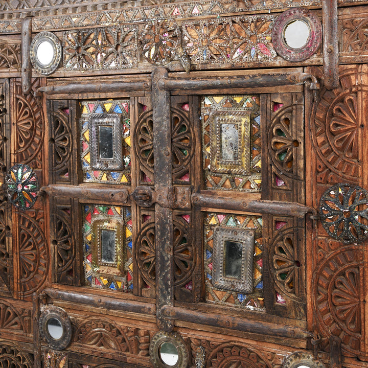 Detail from a carved Indian damchiya chests from The Rann of Kutch are classic examples of the furniture in the area. Their beautiful carving and mirror work is unique and they were used as dowry chests.